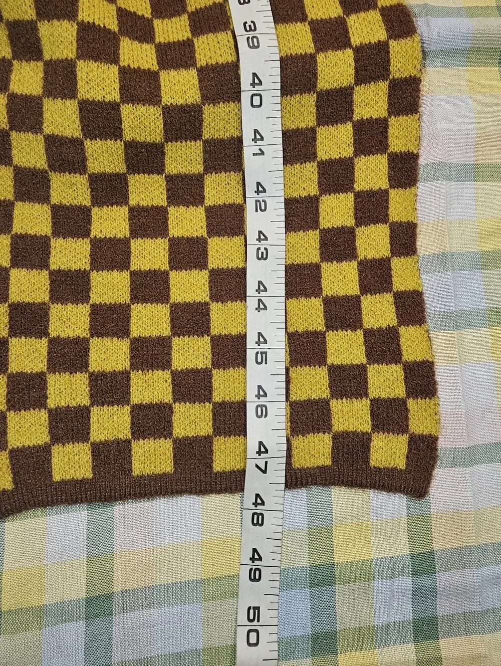 soft knit scarf  brown and mustard yellow checkerboard pattern.